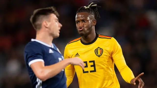 Kieran Tierney is left disappointed as Michy Batshuayi celebrates