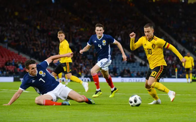 Scotland's John McGinn is left on the deck by Eden Hazard's footwork