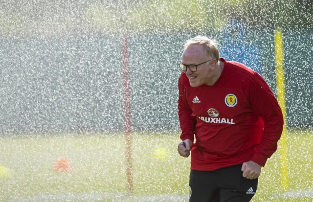 Scotland's Alex McLeish is showered by a sprinkler