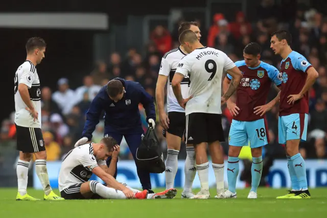 Fulham's Tom Cairney sits injured against Burnley