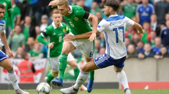 NI's George Saville is challenged by Ervin Zukanovic