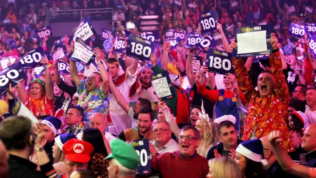 Fans react during the PDC World Championship final