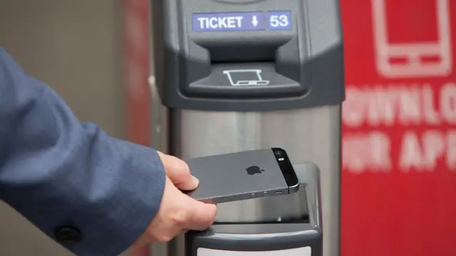 A phone being used at a ticket barrier