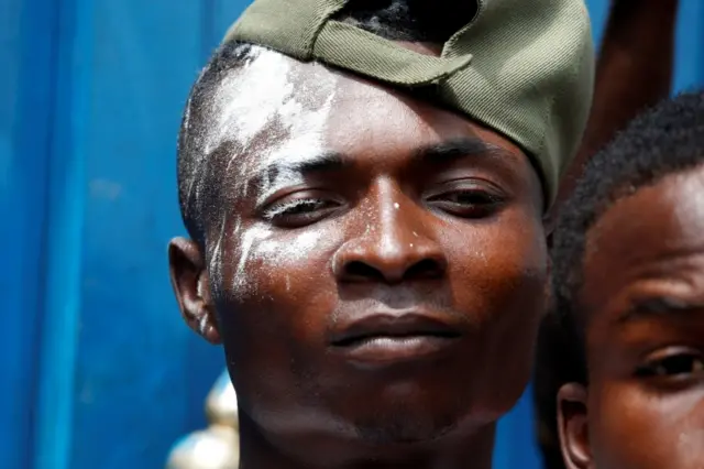 A supporter of Felix Tshisekedi, leader of the Congolese main opposition party, the Union for Democracy and Social Progress (UDPS) who was announced as the winner of the presidential elections, celebrates outside the party"s headquarters in Kinshasa, Democratic Republic of Congo, January 10, 2019.