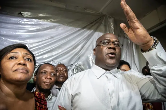 Felix Tshisekedi gestures as he is surrounded by his wife, relatives and supporters of his UDPS party (Union for Democracy and Social Progress), a few minutes after he was declared winner of the presidential election following the announcement of the provisional results by the Independent National Electoral Commission (CENI)