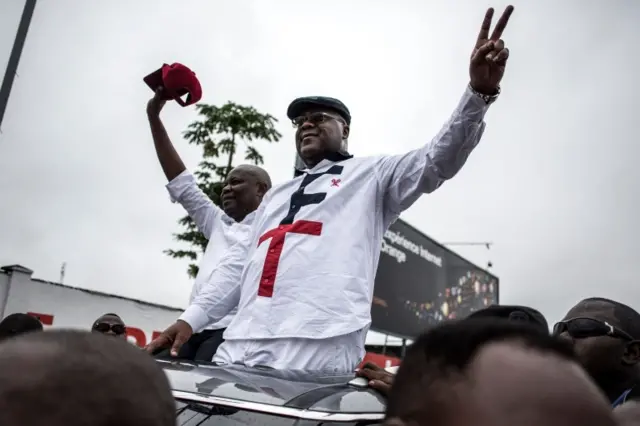 In this file photo taken on November 27, 2018 Congolese main opposition figures, leader of the Union for Democracy and Social Progress (UDPS), Felix Tshisekedi (R) and his running mate leader of the Union for the Congolese Nation (Union pour la Nation Congolaise, UNC) Vital Kamerhe wave from a car to their supporters after arriving in Kinshasa.