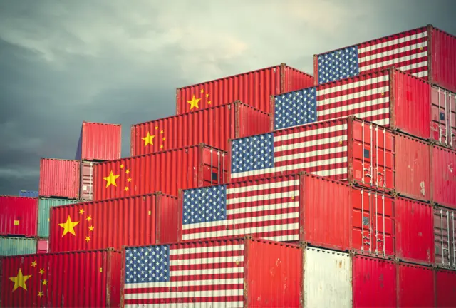 Shipping containers emblazoned with China and US flags