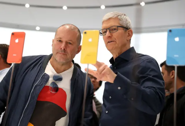 Apple chief design officer Jony Ive (L) and Apple CEO Tim Cook inspect the new iPhone XR