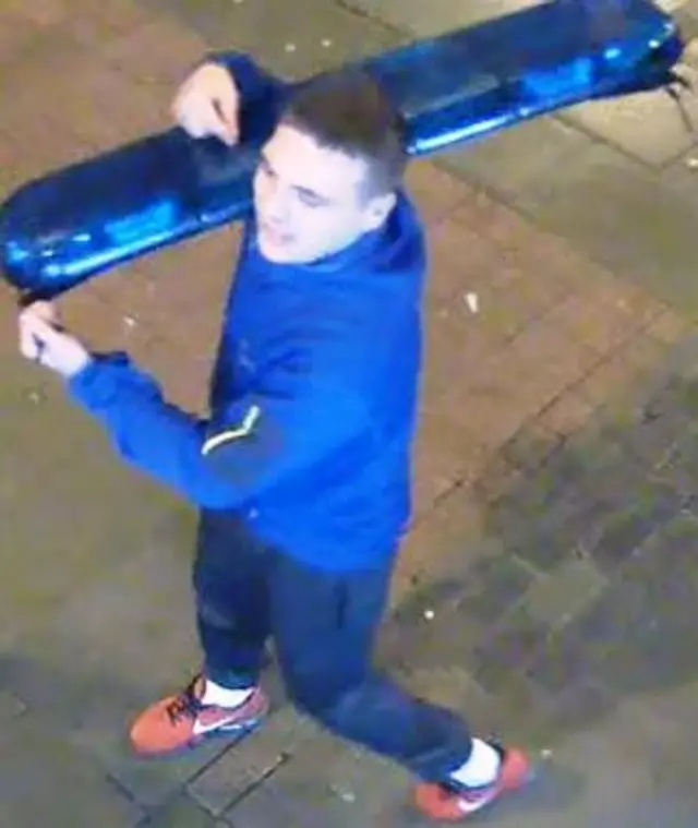 CCTV image of man carrying police light