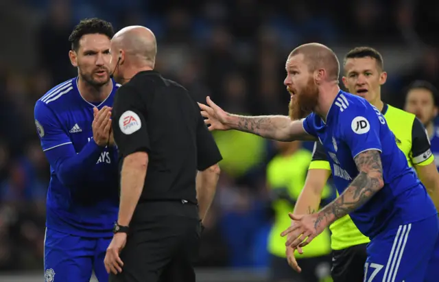 Cardiff players argue with Lee Mason