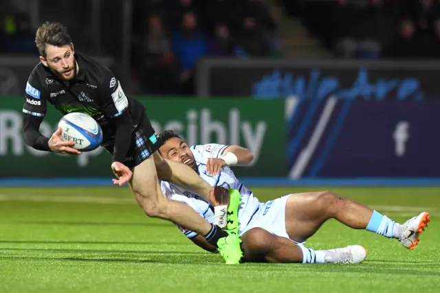 Glasgow Warriors' Tommy Seymour (left) is tackled by Cardiff's Willis Halaholo