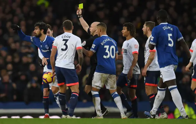 Andre Gomes receives a yellow card