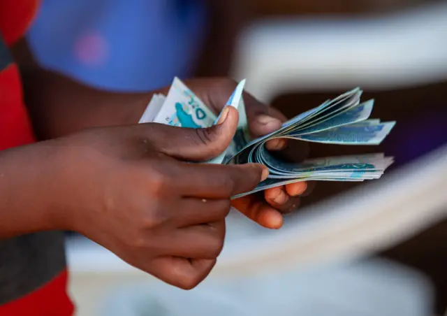 Hands counting Somali shillings