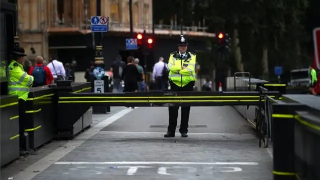 Policeman stands by crash barrier