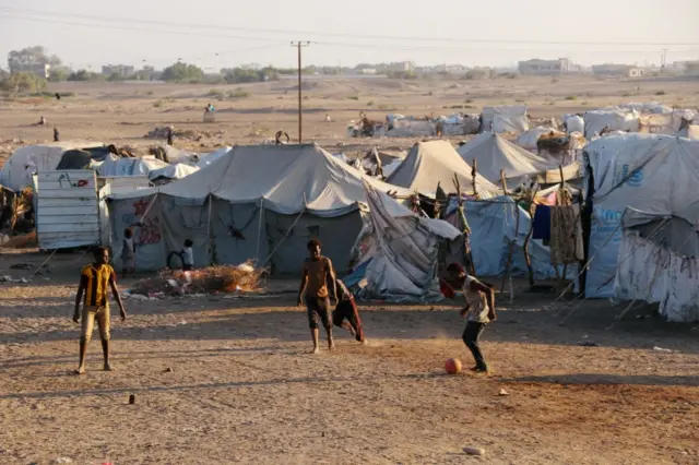 Boys play football near Yemen's Hodeidah Port