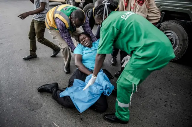 A woman collapses as she is evacuated from the scene of an explosion at the DusitD2 hotel complex on January 15, 2019, in Kenya.