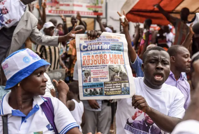 People celebrate on January 15, 2019 in Abidjan after the news that International Criminal Court acquitted former Ivory Coast president Laurent Gbagbo over a wave of post-electoral violence, in a stunning blow to the war crimes tribunal in The Hague.