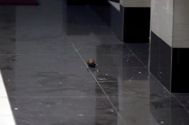 An unexploded grenade on a tiled floor