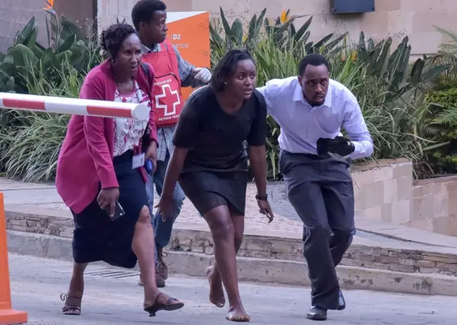 People are evacuated as a gunfight is under way following a blast at the DusitD2 compound hotel and office complex in Nairobi