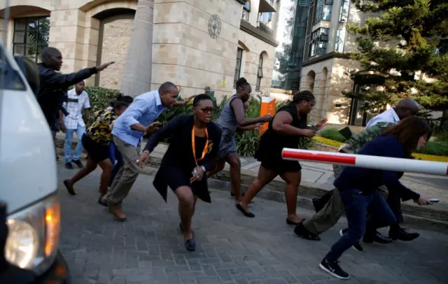 People run as they are evacuated at the scene where explosions and gunshots were heard at the Dusit hotel compound, in Nairobi, Kenya, on 15 January 2019