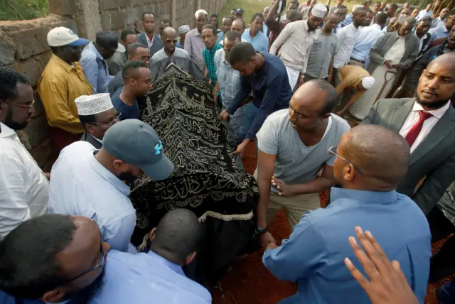 People carry the coffin of Feisal Ahmed Rashid who was killed in an attack on an upscale hotel compound, at the Langata Muslim cemetery, in Nairobi