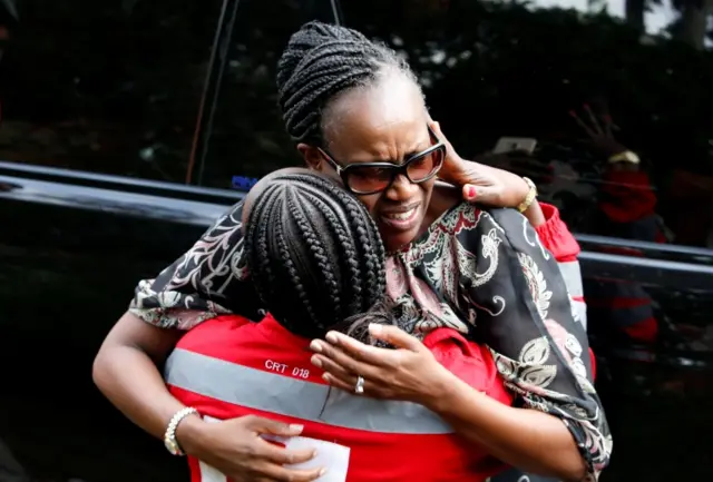 An unidentified woman reacts outside the scene where explosions and gunshots were heard at the Dusit hotel compound