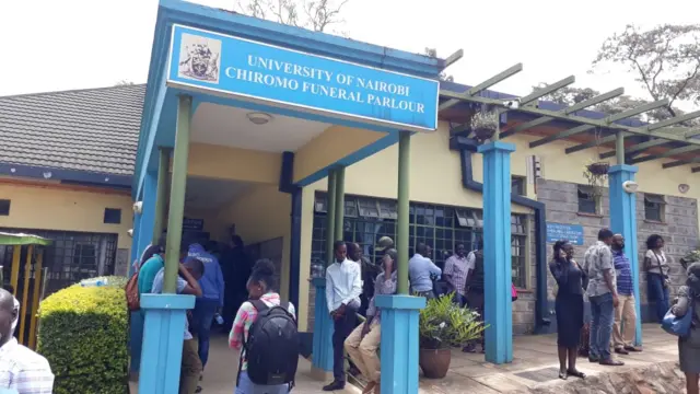 Friends and relatives standing outside University of Nairobi funeral parlour