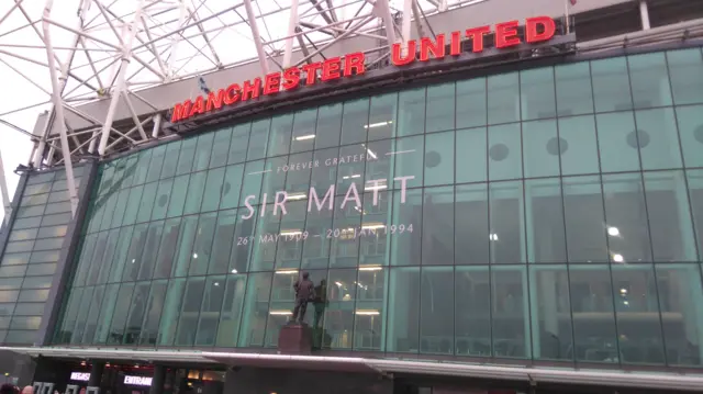 Matt Busby mural on side of stadium