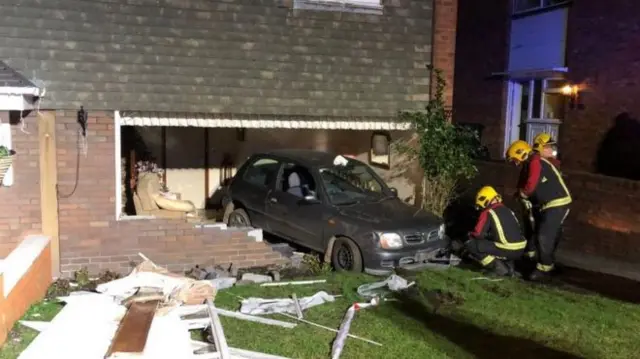 Car after crashing into house