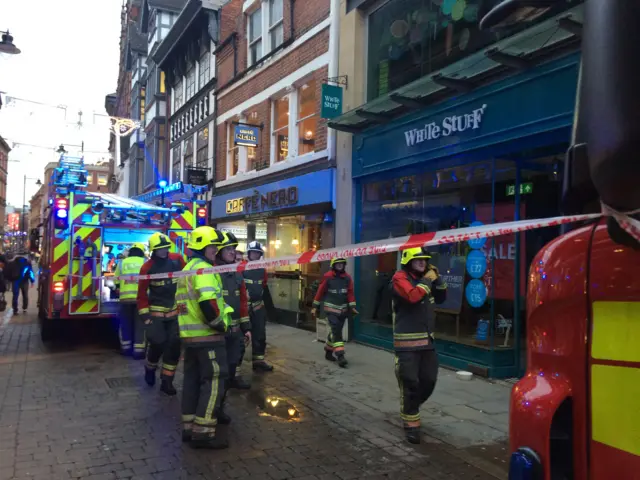 Firefighters outside shops