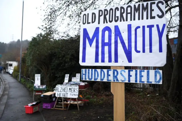 Sign says old programmes for Man City Huddersfield