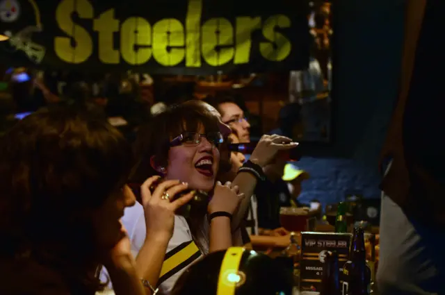 Pittsburgh Steelers fans enjoy a few beers while watching their team