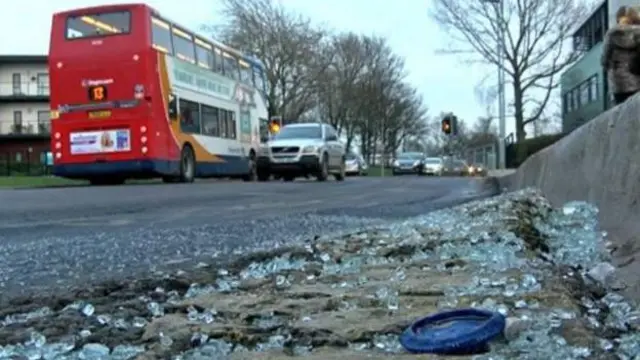 Broken glass at the side of the road