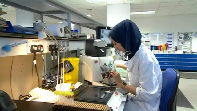 A woman works at a machine