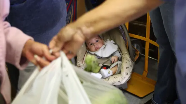 A baby as parents receive a donation