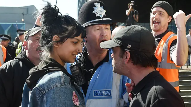 Saffiyah Kahn and an unnamed EDL protester