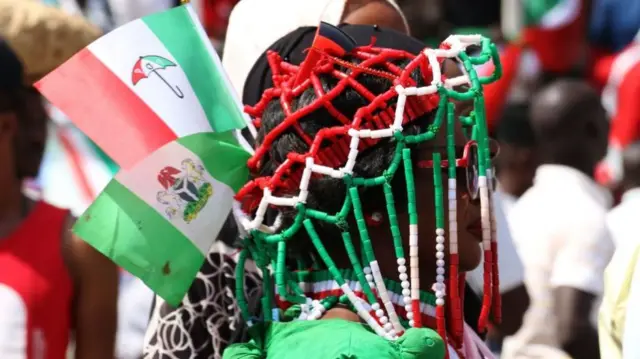 A woman wears People's Democratic Party (PDP) apparel during a campaign rally of Nigerian PDP opposition presidential candidate Atiku Abubakar