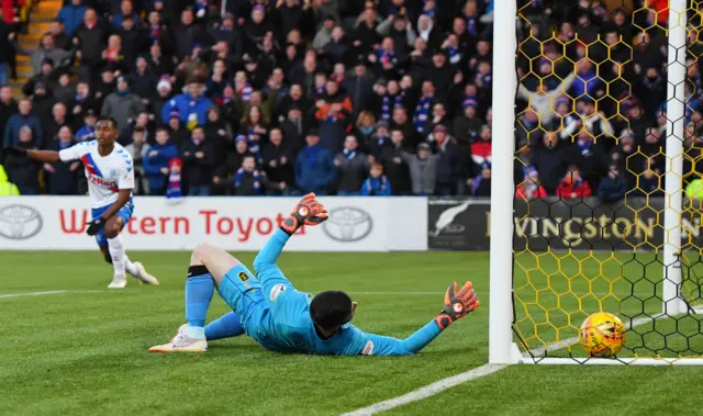 Liam Kelly can only look on in horror as the ball slips under him and into the net