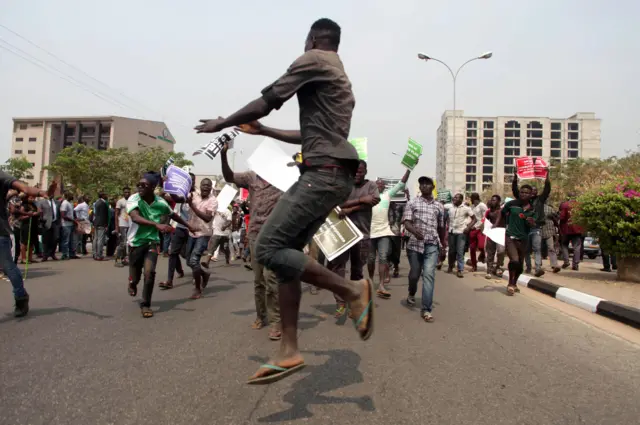 Nigerian protesters march towards the secretariat of the Nigerian Bar Association