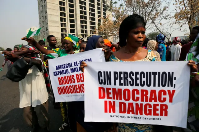 People hold banners during a protest over the suspension of the chief justice of Nigeria (CJN), Walter Onnoghen, in Abuja, Nigeria January 28, 2019.