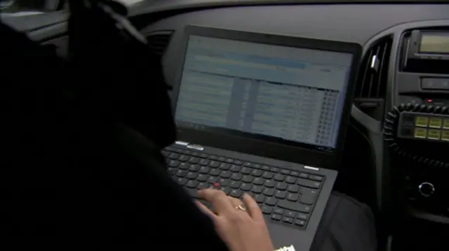 Police officer working on laptop