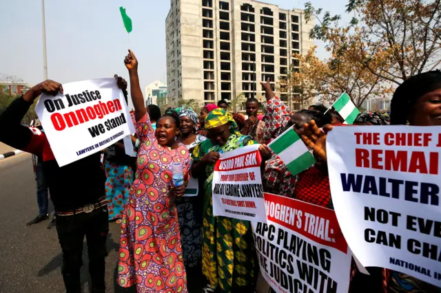 People hold banners during a protest over the suspension of the chief justice of Nigeria (CJN), Walter Onnoghen, in Abuja, Nigeria January 28, 2019.