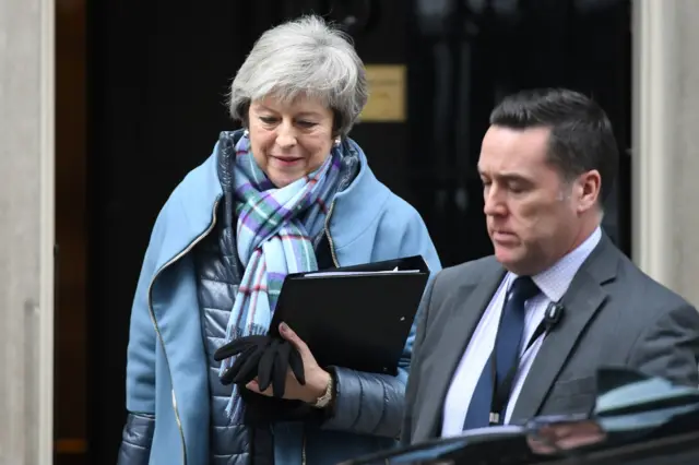 Theresa May leaves Downing Street to head to the debate