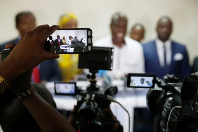 Journalist uses a phone to film as Martin Fayulu, Congolese joint opposition presidential candidate holds a news conference in Kinshasa, Democratic Republic of Congo, December 25, 2018.