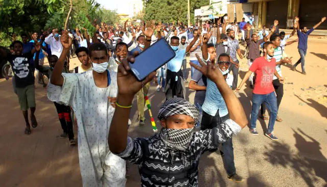 Sudanese demonstrators chant slogans as they march along the street during anti-government protests in Khartoum, Sudan December 25, 2018.