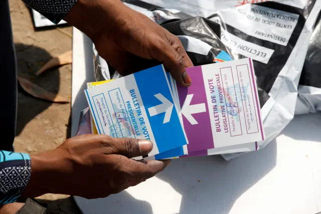 A man holds ballots at Congo's Independent National Electoral Commission (CENI) tallying centre in Kinshasa, Democratic Republic of Congo, 1 January 2019.