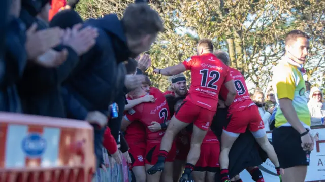 Jersey players celebrate Slowik's try