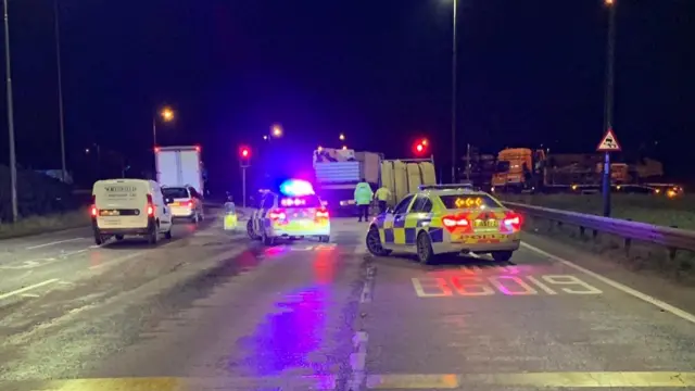 Police around roll of pipe on A38