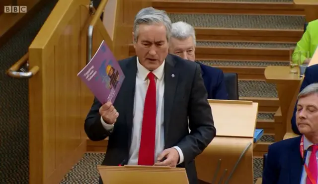 Labour MSP Iain Gray brandishes a copy of Tapping all our Talents 2018