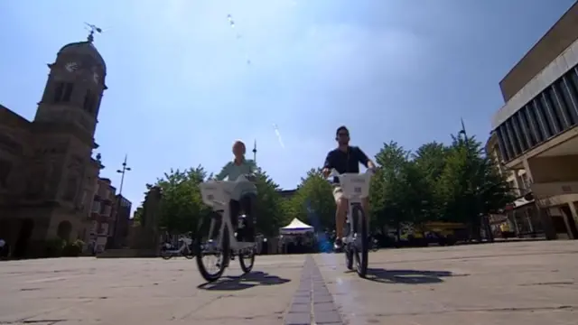 People on electric bikes in Derby